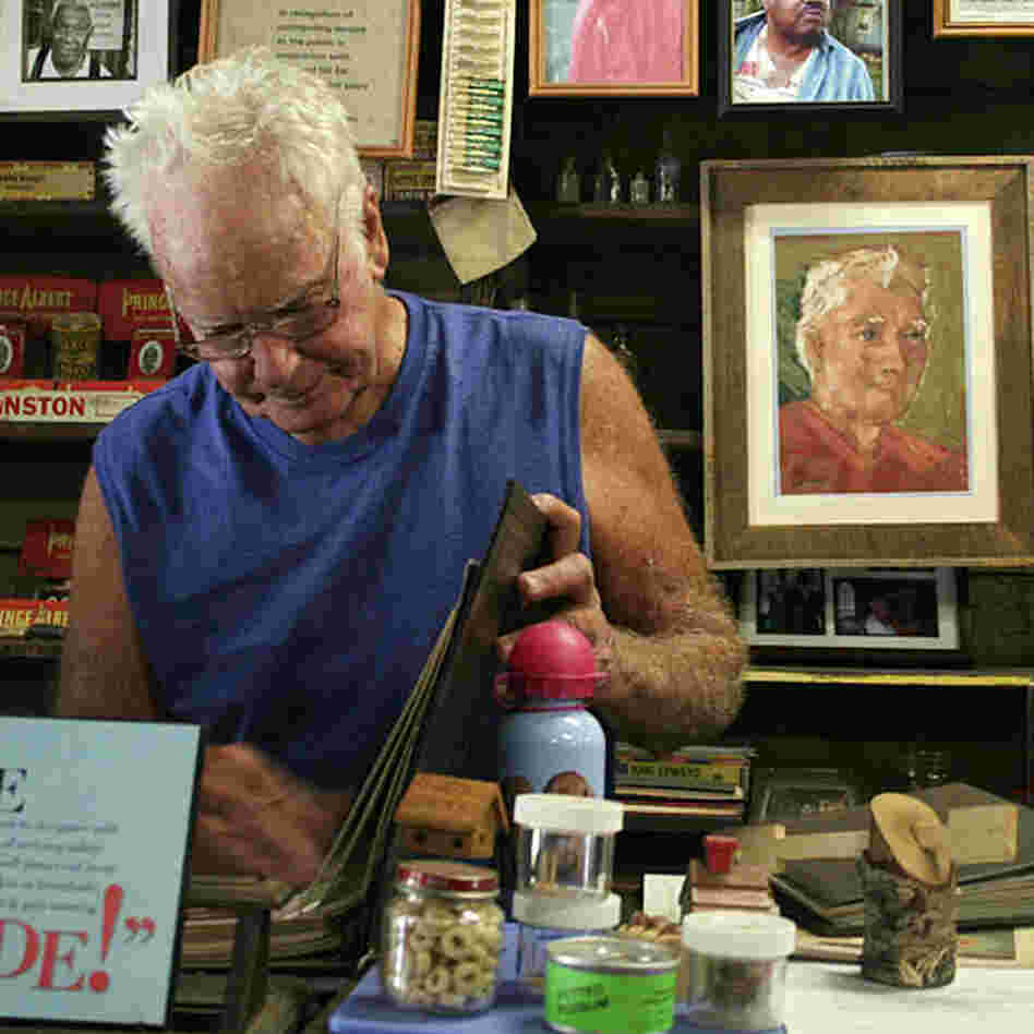 Freddie Wood stands at the counter of the Wood & Swink general store in Evinston, Fla. The store, founded in the late 1800s, houses the oldest post office in Florida.