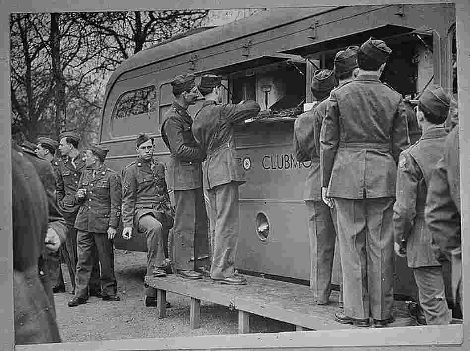 U.S. soldiers receive refreshments, including doughnuts, from an American Red Cross clubmobile in London. Soldiers today still resent a Red Cross move to charge for doughnuts. U.S. soldiers receive refreshments, including doughnuts, from an American Red Cross clubmobile in London. Soldiers today still resent a Red Cross move to charge for doughnuts.