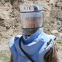 A de-mining expert demonstrates how to find land mines in a training area near Hakim Village in central Afghanistan, where Soviet mines dating to the 1980s are still a danger.