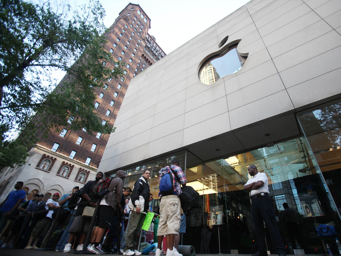 Hundreds of people line up outside an Apple store in Chicago to buy the iPhone 4 in 2010. Apple had removed its products from EPEAT's registry of environmentally friendly electronic devices but later reversed course.