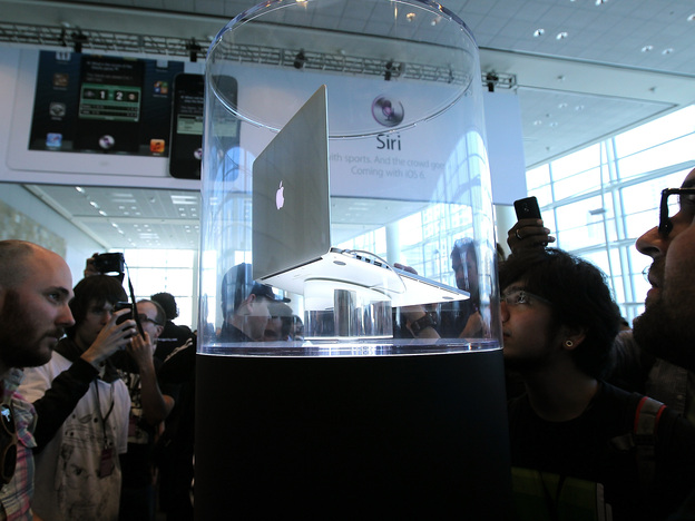 Attendees of Apple's 2012 World Wide Developers Conference look at the new MacBook Pro with Retina display.