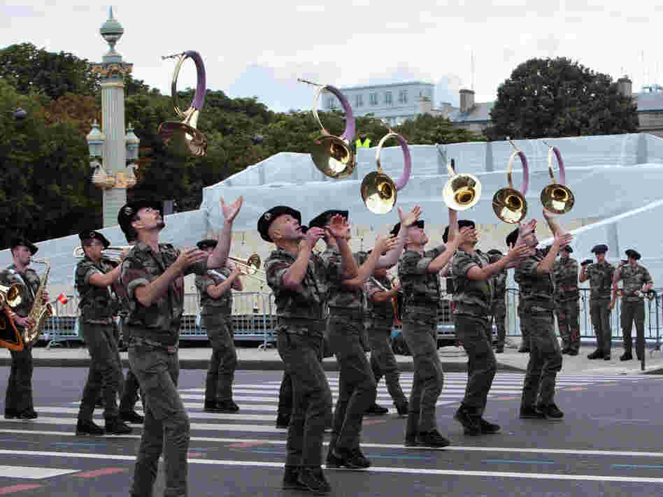 A French military brass band parades on the Champs-Elysee during a rehearsal as part of the Bastille Day celebrations, which take place Saturday.