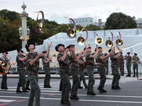A French military brass band parades on the Champs-Elysee during a rehearsal as part of the Bastille Day celebrations, which take place Saturday.