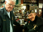 Navy veteran Howard Dunn and Army veteran Tom Kaine remember when the Red Cross briefly charged servicemen for doughnuts during World War II. Many veterans still resent it.