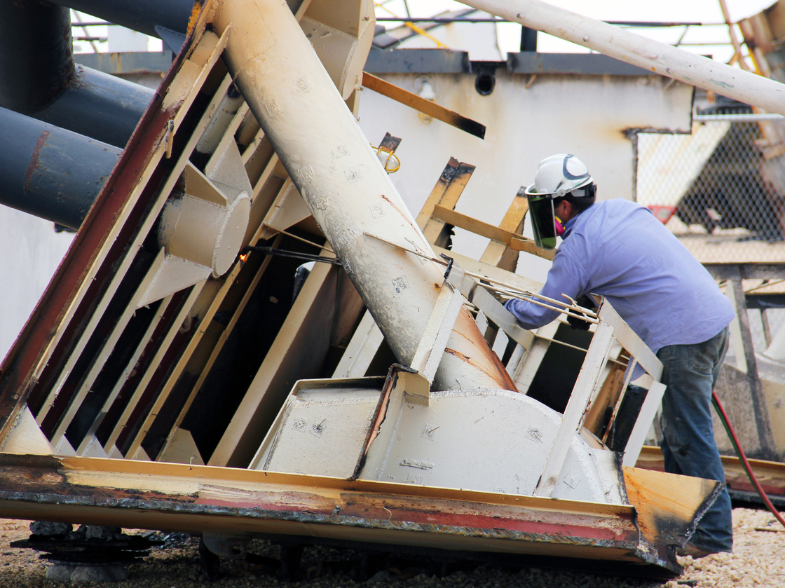 A ship cutter helps dismantle a ship at the Bay Bridge Texas recycling yard.