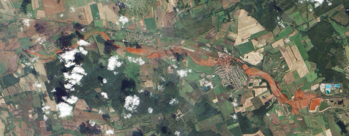 Aerial view of the toxic red sludge flowing from a breached waste reservoir (diamond shape at right) through the villages of Kolontar and Devecser.
