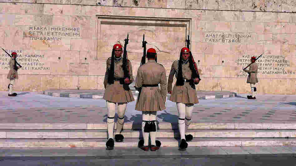 Evzones, the Greek honor guard, watch over Syntagma Square in Athens, the site of numerous anti-austerity protests in the last two years.