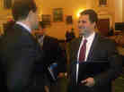 Joe Olivo (right) talks to Dave Camp (left), Chairman of House Ways and Means Committee, after testifying before the House in Jan. 2010.