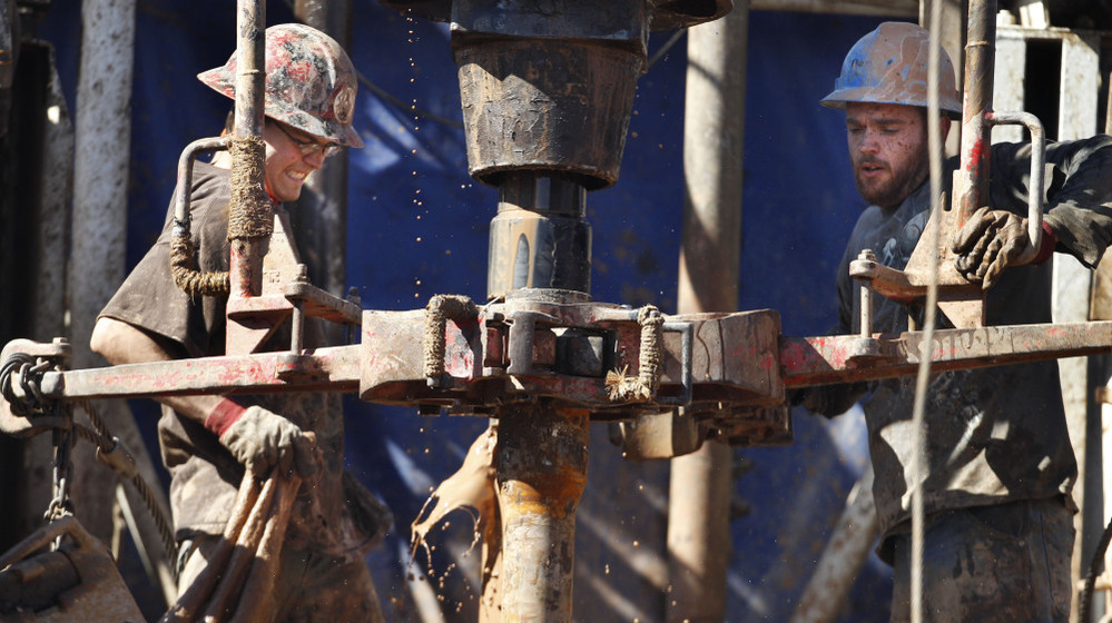 Oil field workers drill into the Gypsum Hills near Medicine Lodge, Kan. Hydraulic fracturing, or "fracking," to coax out oil and gas has led to a natural gas boom, but some remain concerned of the potential environmental impact.