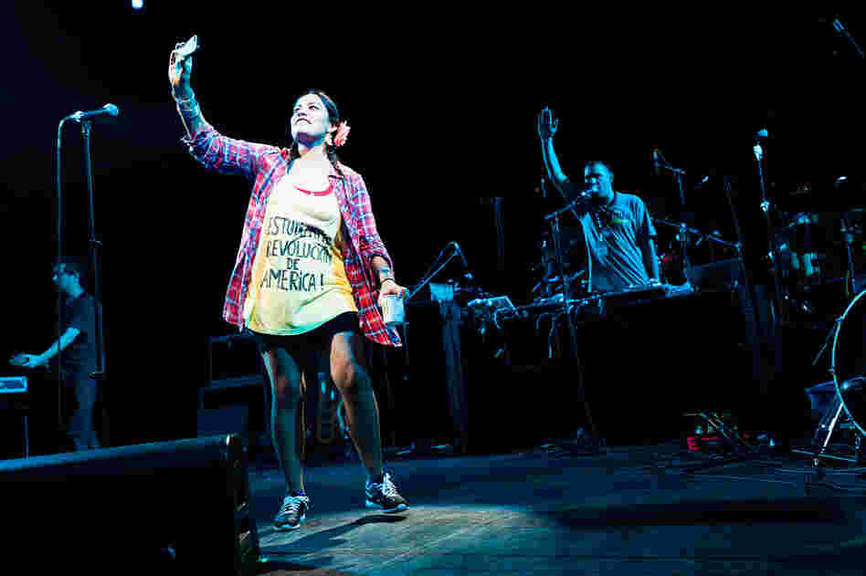 Tijoux took pictures of the crowd as it cheered. More than 7,000 people packed the Prospect Park Bandshell, while just as many were turned away outside.