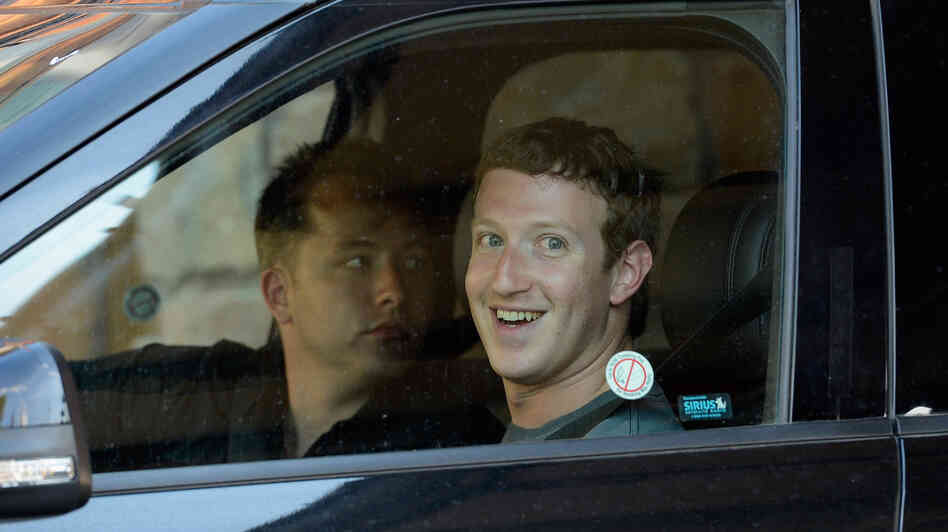 Mark Zuckerberg, right, and Andrew Houston, founder and chief executive of Dropbox, wait in a parked car for the traffic to clear out at the Sun Valley Lodge during the Allen & Company Sun Valley Conference last week.