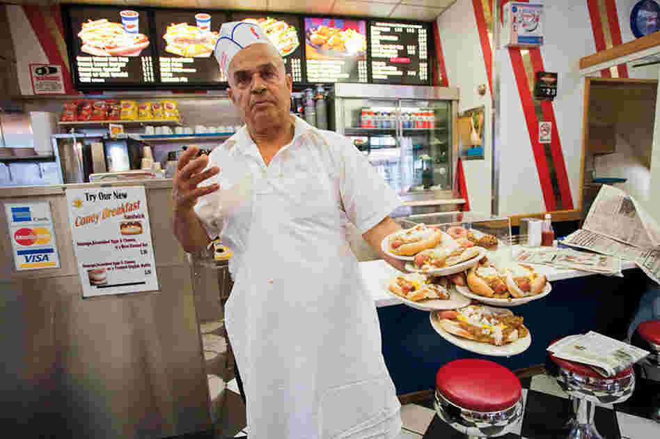 Jerry Abu El Hawa serves up hot dogs at American Coney Island, one of Detroit's most storied Coney joints.