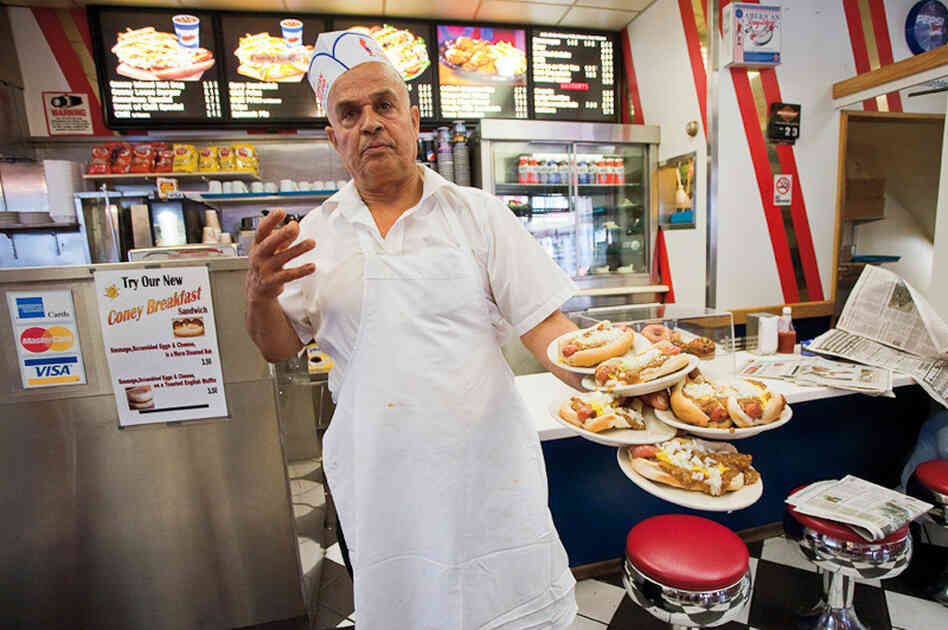 Jerry Abu El Hawa serves up hot dogs at American Coney Island, one of Detroit's most storied Coney joints.