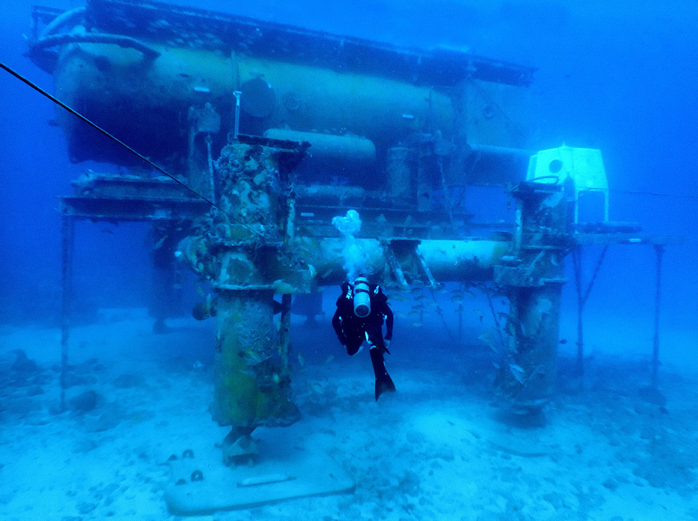 A diver swims by the Aquarius Reef Base, a permanent working undersea laboratory off Key Largo, Fla., in the Florida Keys National Marine Sanctuary. The Obama administration cut the lab's funding, and now scientists are trying to save it.