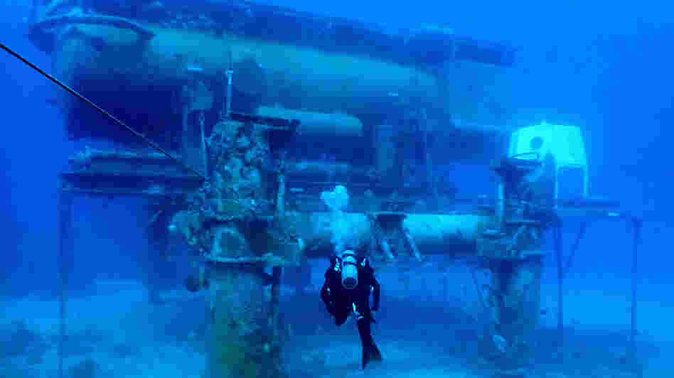 A diver swims by the Aquarius Reef Base, a permanent working undersea laboratory off Key Largo, Fla., in the Florida Keys National Marine Sanctuary. The Obama administration cut the lab's funding, and now scientists are trying to save it.
