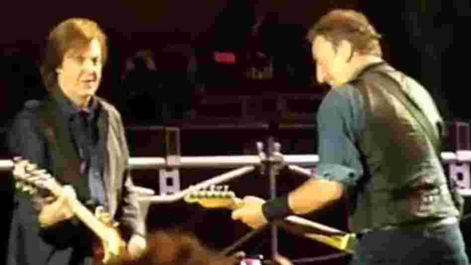Paul McCartney, left, and Bruce Springsteen during Saturday's show in Hyde Park — before the plug was pulled. Frame grab from video posted by "BenR753" on YouTube.