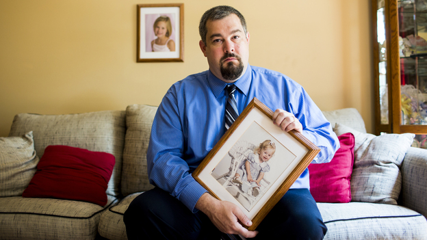 Chris Truitt holds a photo of his daughter, Alyssa, who died when she was 2, at his home in De Forest Wis. After donating her organs and tissues, he decided on a career change that made him rethink tissue donation.