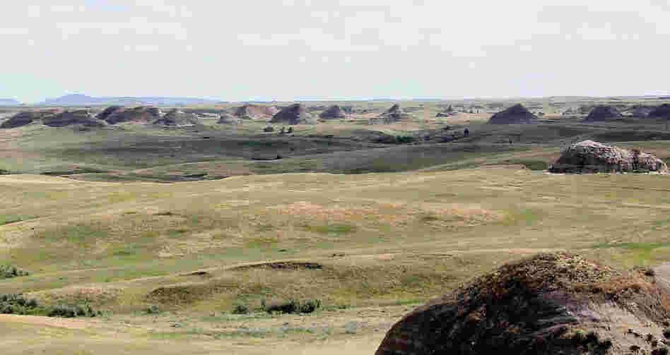 Rock formations stretch off in the distance, seen from Elkhorn Ranch.