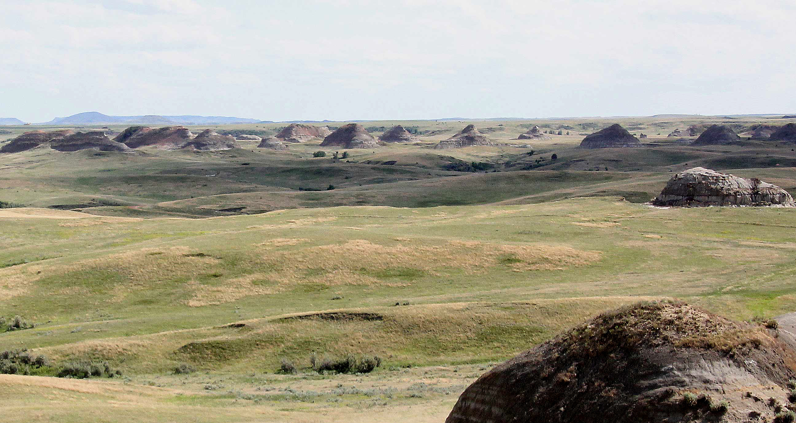 Rock formations stretch off in the distance, seen from Elkhorn Ranch.