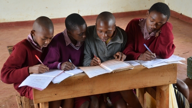 Kenya has made its public schools free, which has dramatically increased the number of students. But this has also led to overcrowding. Here, four boys share a desk and a single textbook at the Amboni Secondary School in central Kenya. Kenya has made its public schools free, which has dramatically increased the number of students. But this has also led to overcrowding. Here, four boys share a desk and a single textbook at the Amboni Secondary School in central Kenya.