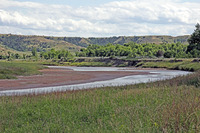The Little Missouri River curves just in front of the Elkhorn Ranch site. The river flows north here to join the Missouri River.