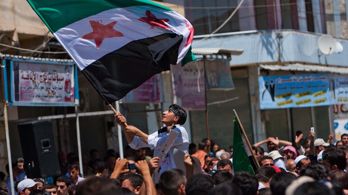 Syria's ongoing fighting is increasingly a sectarian conflict with the majority Sunni Muslims facing off against the Alawites who make up most of the country's ruling elite. Here, government opponents rally in the northern town of Mareh on June 29.