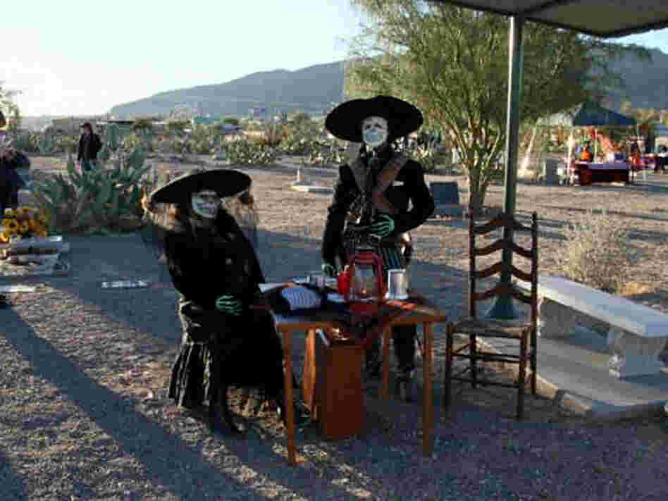 A couple celebrates Dia de los Muertos at the Concordia Cemetery.