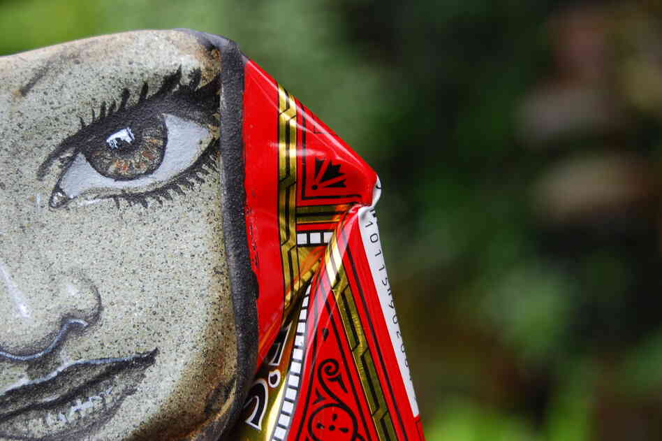 Half of a face, peeping out from a Lyle's Black Treacle can.