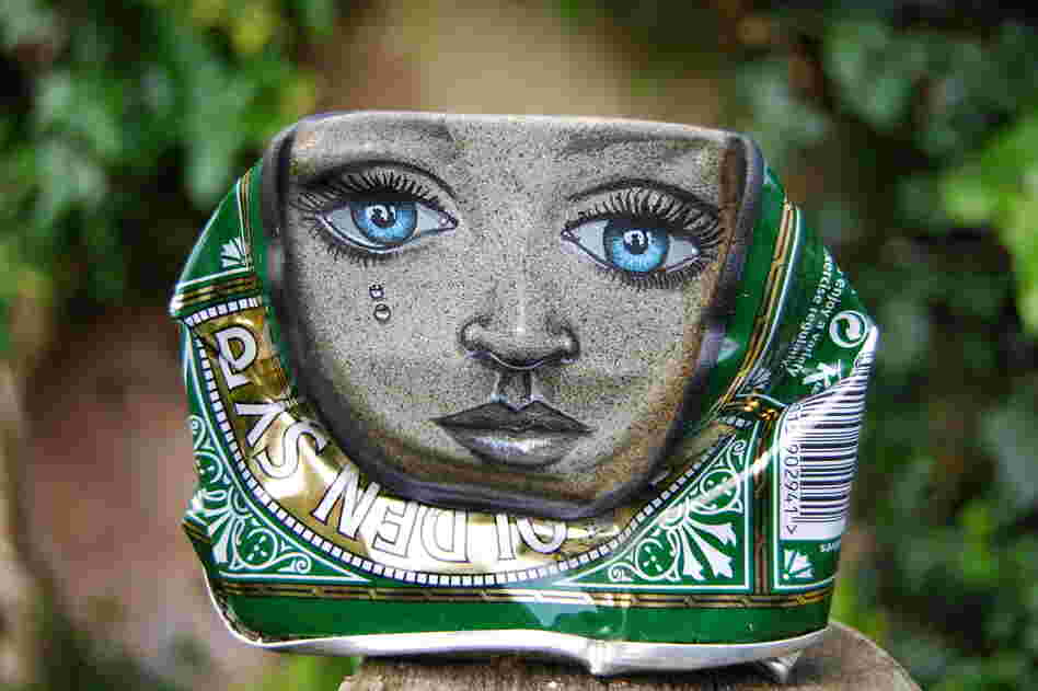 A lady face painted on a Lyle's Golden Syrup can.
