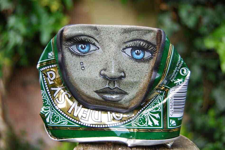 A lady face painted on a Lyle's Golden Syrup can.