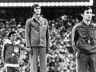 Marathon medal winners listen to the anthem from the victory stand during the presentation ceremony at the XXI Summer Olympic Games in Montreal in 1976. From left, Frank Shorter, U.S.A., silver; Waldemar Cierpinski, East Germany, gold, Olympic record; and Karel Lismont, Belgium, bronze. Evidence of doping by the East Germans suggests that Shorter deserved the gold medal. Marathon medal winners listen to the anthem from the victory stand during the presentation ceremony at the XXI Summer Olympic Games in Montreal in 1976. From left, Frank Shorter, U.S.A., silver; Waldemar Cierpinski, East Germany, gold, Olympic record; and Karel Lismont, Belgium, bronze. Evidence of doping by the East Germans suggests that Shorter deserved the gold medal.