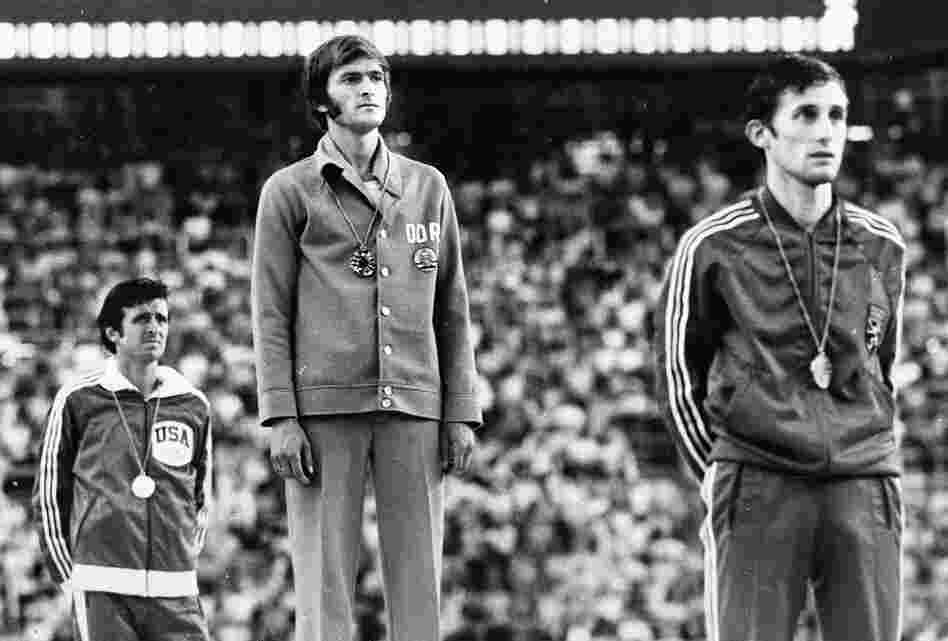 Marathon medal winners listen to the anthem from the victory stand during the presentation ceremony at the XXI Summer Olympic Games in Montreal in 1976. From left, Frank Shorter, U.S.A., silver; Waldemar Cierpinski, East Germany, gold, Olympic record; and Karel Lismont, Belgium, bronze. Evidence of doping by the East Germans suggests that Shorter deserved the gold medal.