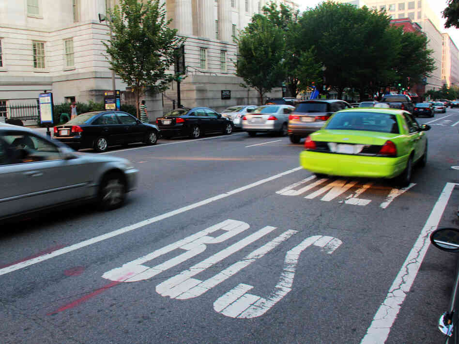 A taxi drives down a bus lane in Washington, D.C. A taxi drives down a bus lane in Washington, D.C.