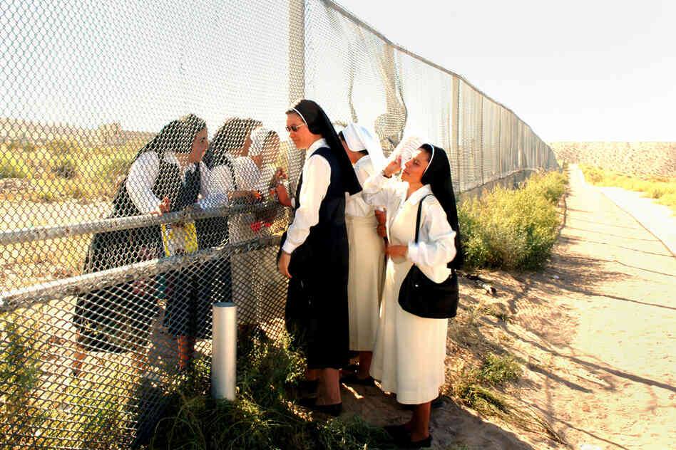 Sisters at the Border, 2007. Nuns meet at the border of Anapra, N.M. (left), and Barrio Anapra, Juarez. The nuns in Mexico cannot cross for various reasons — except on the day of a Mass for immigrants, held every November in the U.S.