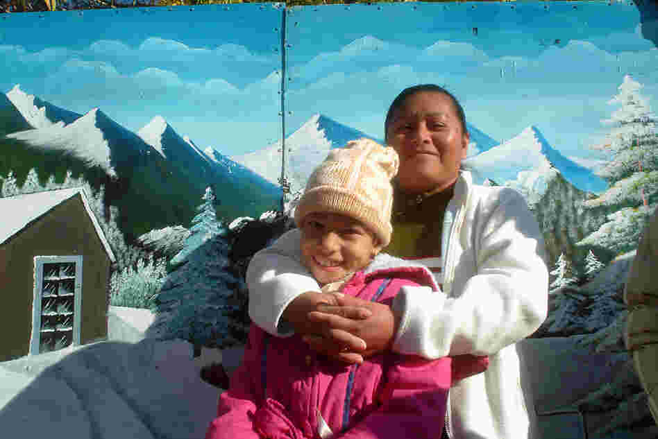 Las Sierras de Juarez, 2006. A mother and daughter in the Plaza de Juarez in front of a photographer's backdrop.