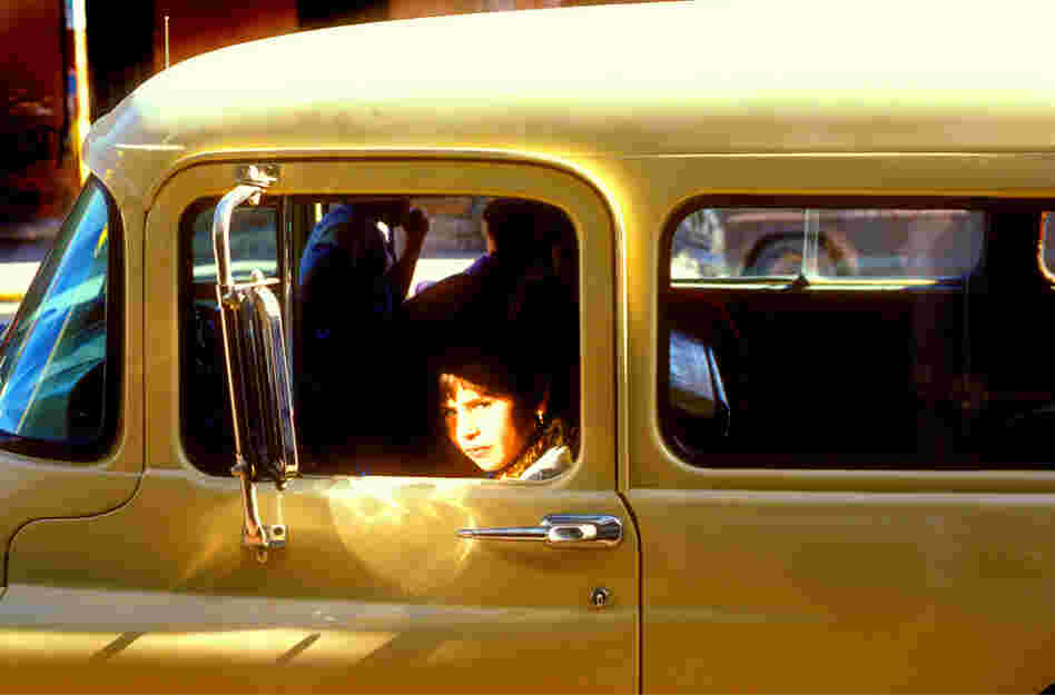 Wary girl in a GMC truck, downtown El Paso, 1980