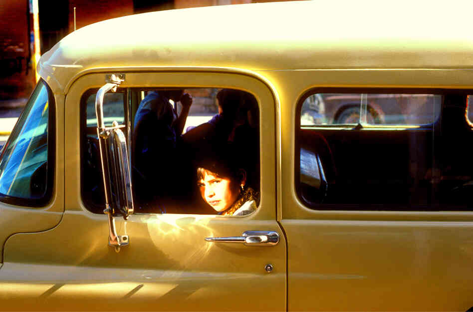 Wary girl in a GMC truck, downtown El Paso, 1980