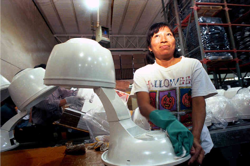 Woman in an assembly plant in Juarez (known as a maquila), 1999.