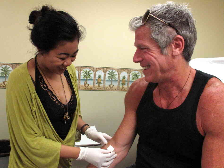 Nurse Priscila-Grace Gonzaga with Gregg Cassin, a San Francisco gay man who has been infected with HIV since the early 1980s. He's a volunteer in a cutting-edge gene therapy experiment to see whether HIV-infected people can be given an immune system that is invulnerable to HIV infection.