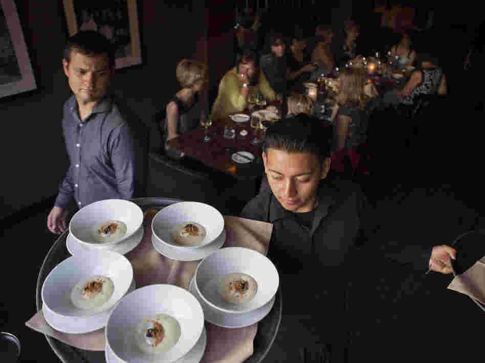 Waiters at Ardeo-Bardeo in Washington, D.C. serve smoked white potato mousse with egg and caviar.