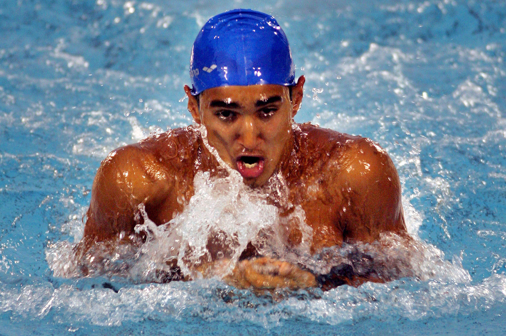 India's Sandeep Sejwal swims his way to gold in the 100-meter men's breaststroke at the 2006 South Asian Games in Sri Lanka. Sejwal, who competed in the Beijing Olympics two years later, has a government job with India's railway that accommodates his heavy training schedule.