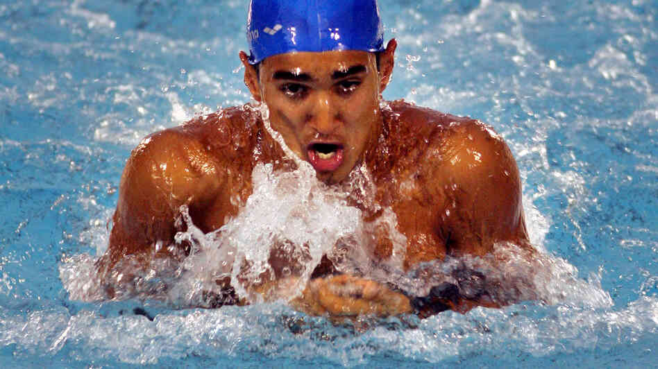India's Sandeep Sejwal swims his way to gold in the 100-meter men's breaststroke at the 2006 South Asian Games in Sri Lanka. Sejwal, who competed in the Beijing Olympics two years later, has a government job with India's railway that accommodates his heavy training schedule.
