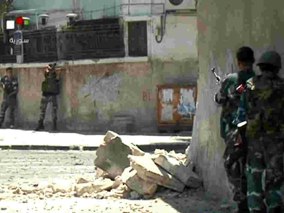 Video taken from Syrian TV purportedly shows government forces taking up position during clashes with rebels Wednesday in the Al-Midan district of Damascus. Video taken from Syrian TV purportedly shows government forces taking up position during clashes with rebels Wednesday in the Al-Midan district of Damascus.
