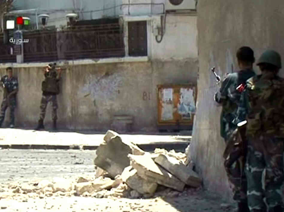 Video taken from Syrian TV purportedly shows government forces taking up position during clashes with rebels Wednesday in the Al-Midan district of Damascus. Video taken from Syrian TV purportedly shows government forces taking up position during clashes with rebels Wednesday in the Al-Midan district of Damascus.