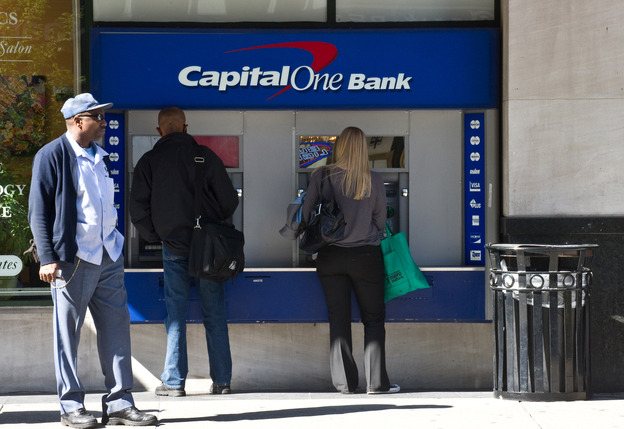 People use an ATM at a Capital One Bank branch in Washington in April 2012.