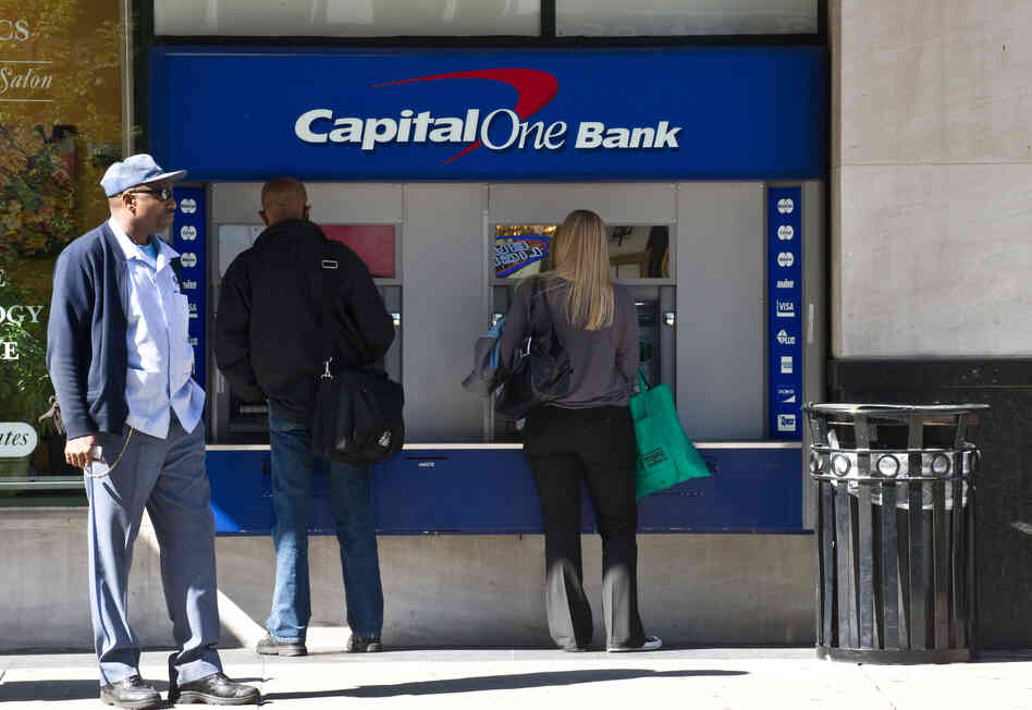 People use an ATM at a Capital One Bank branch in Washington in April 2012.