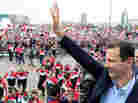 Syrian President Bashar Assad waves at supporters during a rare public appearance in Damascus on Jan. 11.