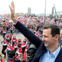 Syrian President Bashar Assad waves at supporters during a rare public appearance in Damascus on Jan. 11. Syrian President Bashar Assad waves at supporters during a rare public appearance in Damascus on Jan. 11.