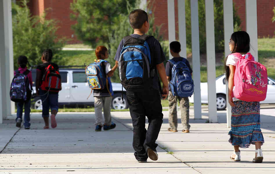 Students return for their first day of classes at Barwell Road Elementary School in Raleigh, N.C., on July 9.