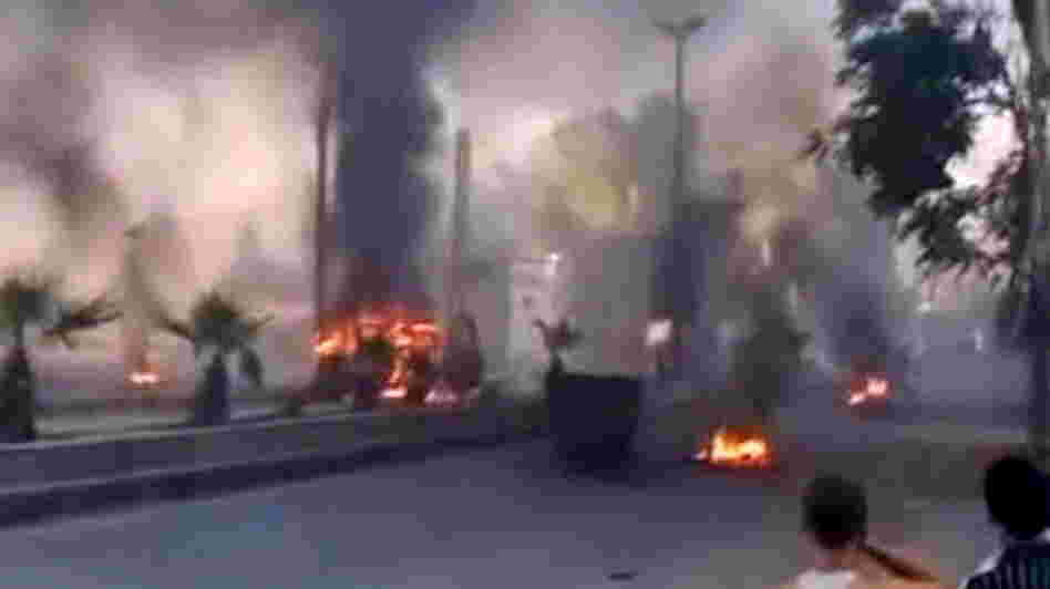 An image grab taken from a video uploaded on YouTube on Wednesday shows smoke billowing from burning tires and trash containers in Damascus.